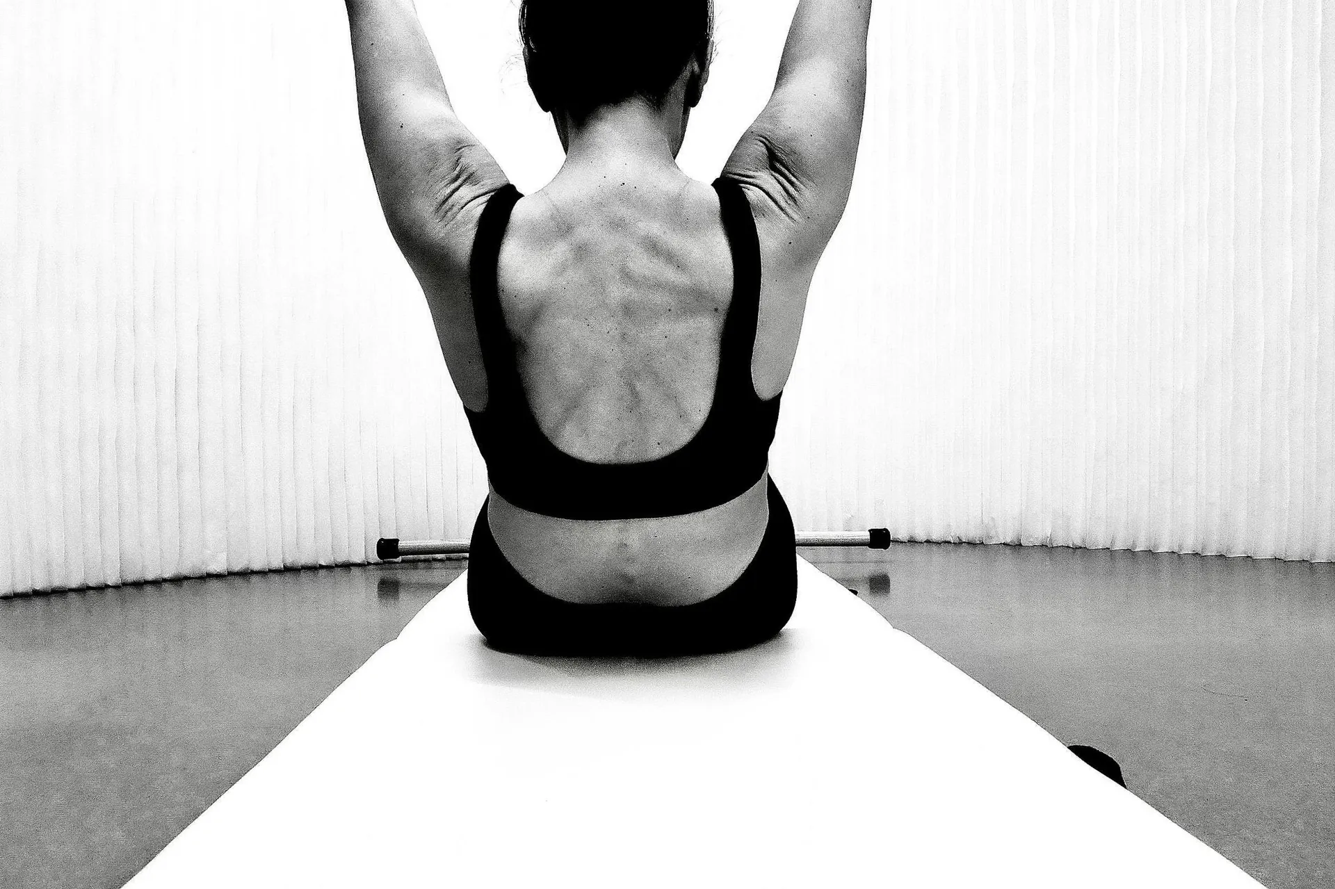 A client practicing Pilates in the studio