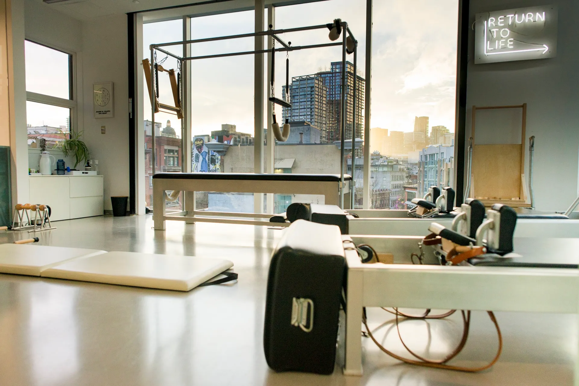 Light-filled rhōmē Pilates studio with authentic apparatus and city views